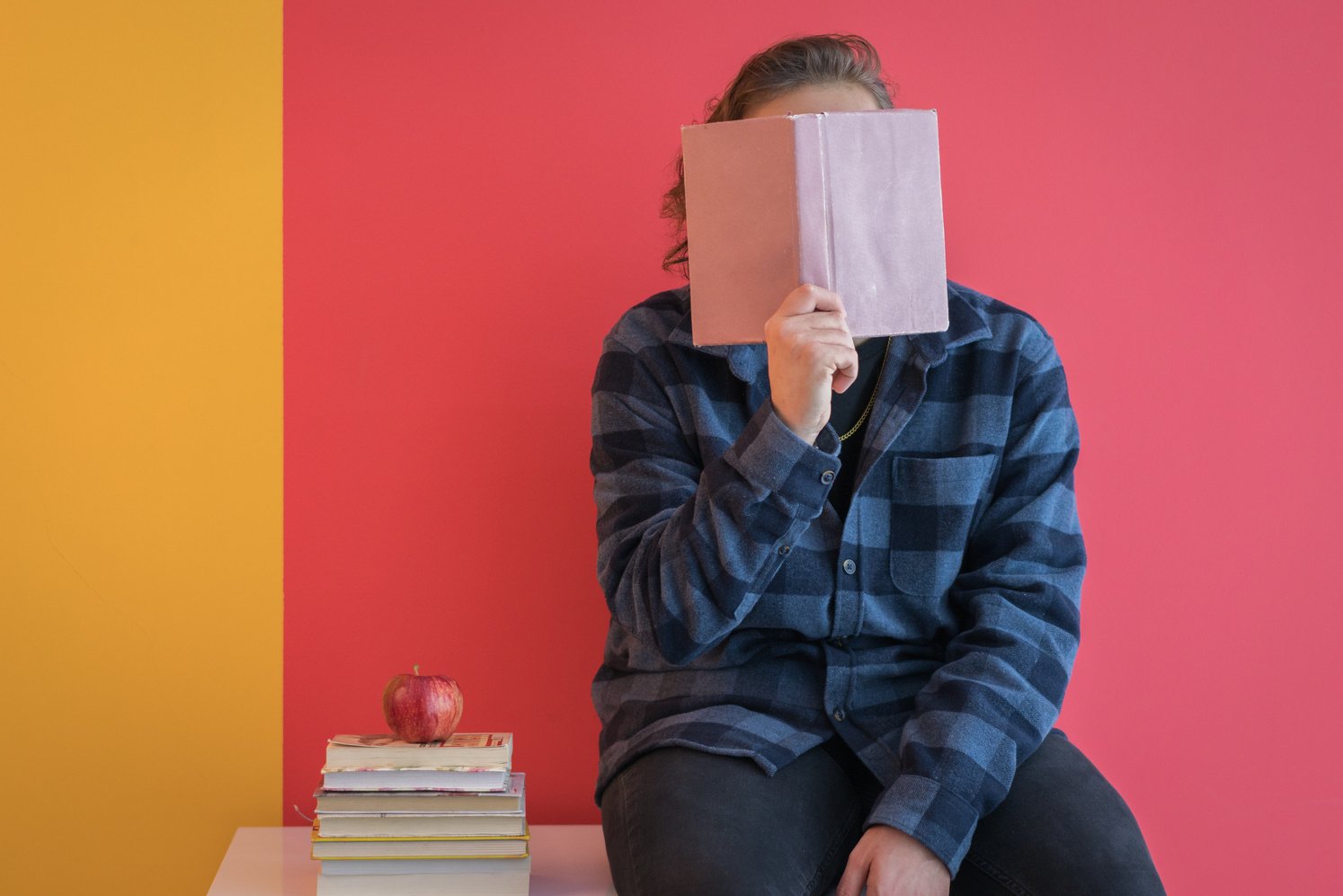 Handsome Student Holding A Book In Front Of Face